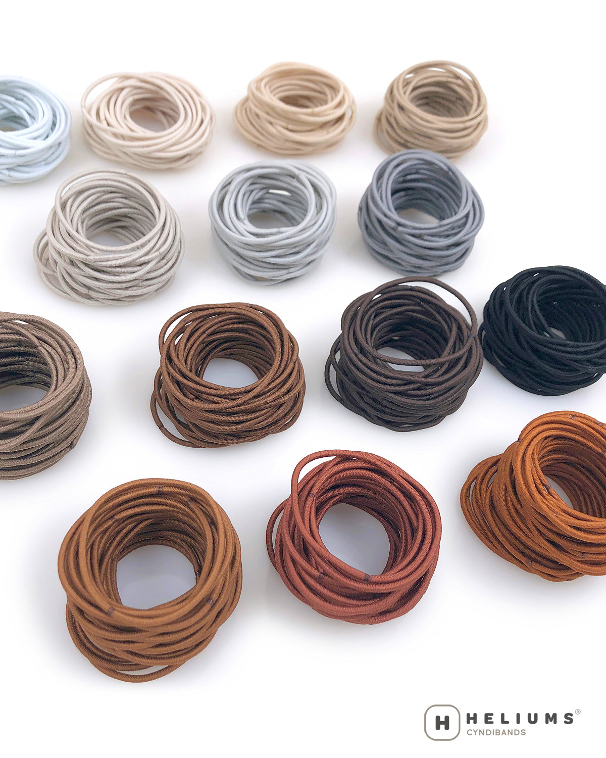 Set of hair bands in various colors on a white background with 'Heliums' branding.