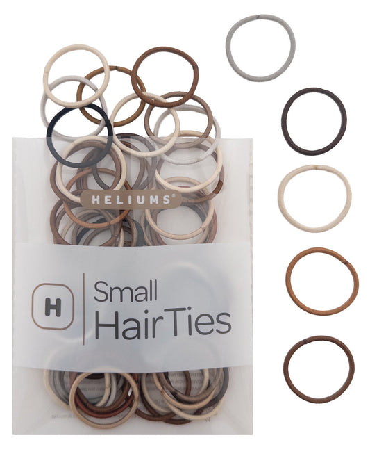 Heliums Small HairTies in a clear plastic bag with a white label, shown alongside several loose hair ties in different colors on a white background.