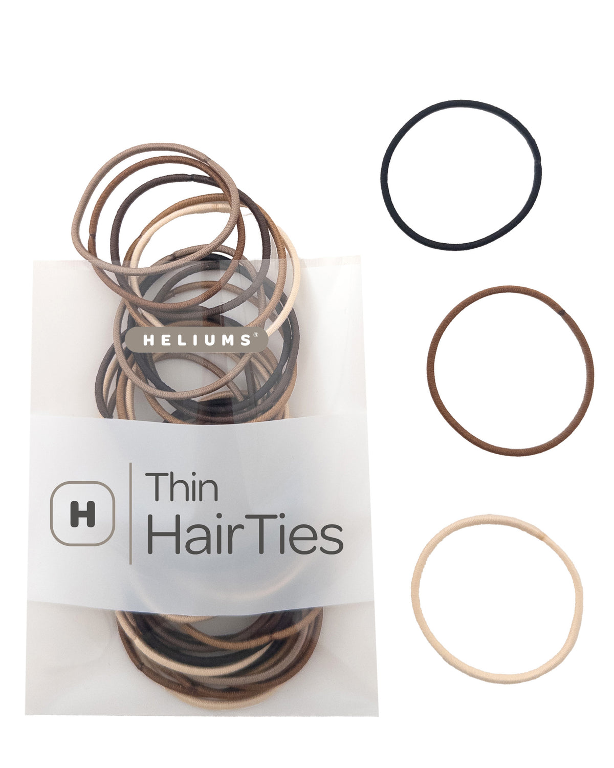 Heliums Thin Hair Ties set in a clear plastic bag with three loose hair ties displayed on the right in black, brown, and blonde.