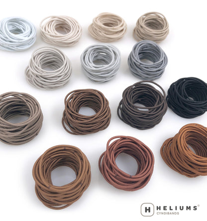 Stacks of Heliums thin hair ties in 14 neutral shades
