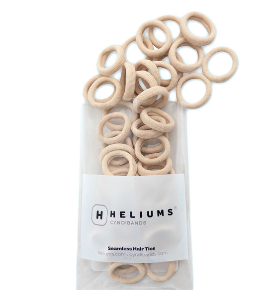 Pack of Heliums Extra Small Seamless Hair Ties in cream color on a white background