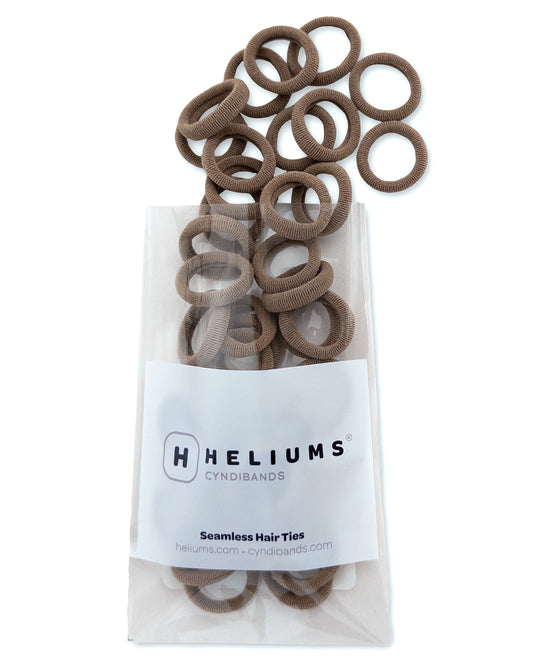 Pack of Heliums Extra Small Seamless Hair Ties in light brown color on a white background