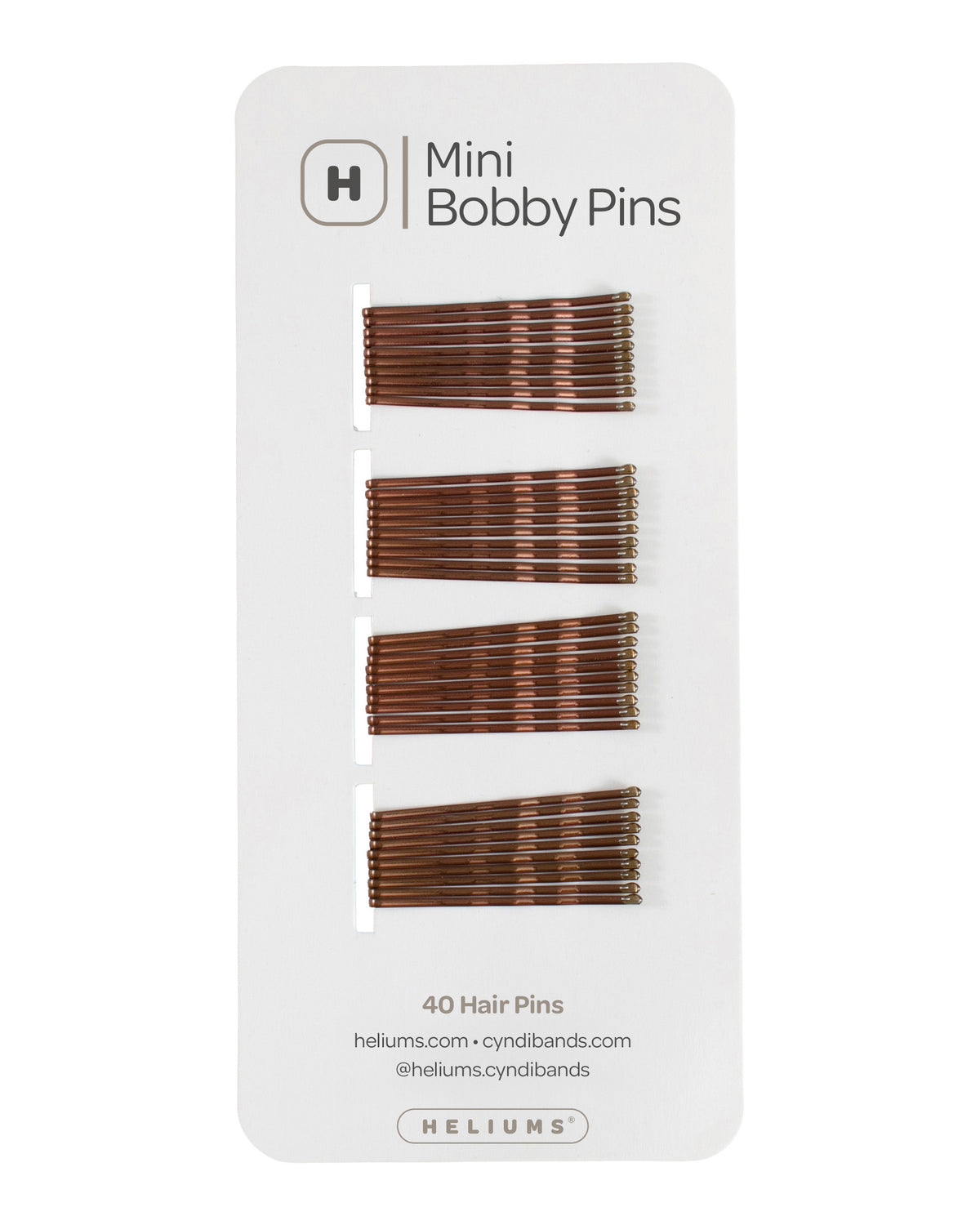 Heliums mini hair pins in brown shades, displayed on a white backing card with the Heliums brand logo.