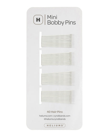 Heliums 40 mini bobby pins on a white display card, showing four sets of white hair pins.