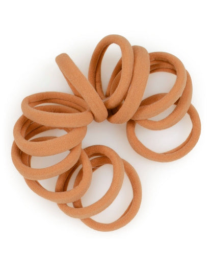 Spiraled stack of Gold seamless elastic hair ties.