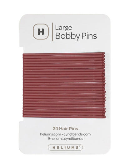 Heliums 24 Bobby Pins in a auburn red color, packaged on a white backing card with the Heliums logo.