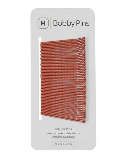 Packaging of Heliums brand 2-inch wavy auburn color bobby pins, displaying multiple pins on white card with the brand logo and name.