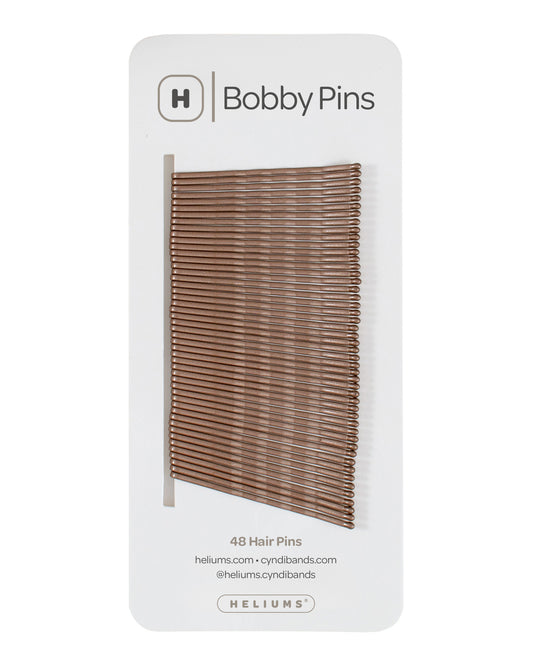 Packaging of Heliums brand 2-inch wavy light brown color bobby pins, displaying multiple pins on white card with the brand logo and name.