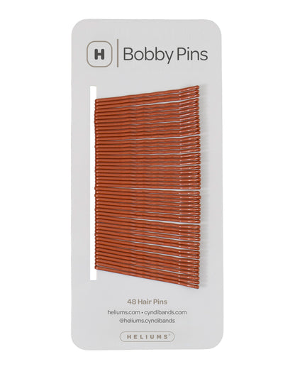 Packaging of Heliums brand 2-inch wavy copper color bobby pins, displaying multiple pins on white card with the brand logo and name.