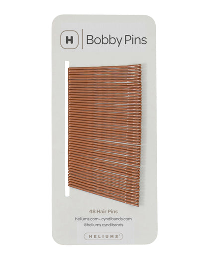 Packaging of Heliums brand 2-inch wavy ginger color bobby pins, displaying multiple pins on white card with the brand logo and name.